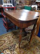 A George III mahogany turnover top table on turned legs