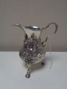 A George III silver cream jug, London marks (rubbed).