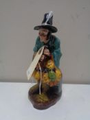 A Royal Doulton figure, The Mask Seller, HN 2103.