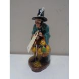 A Royal Doulton figure, The Mask Seller, HN 2103.