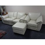 A Violino cream leather two seater settee with central arm rests and cup holders,