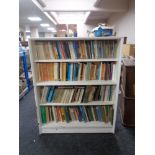 A set of mid 20th century Gibbs Furniture - painted open shelves containing four shelves of books