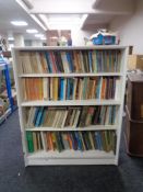 A set of mid 20th century Gibbs Furniture - painted open shelves containing four shelves of books