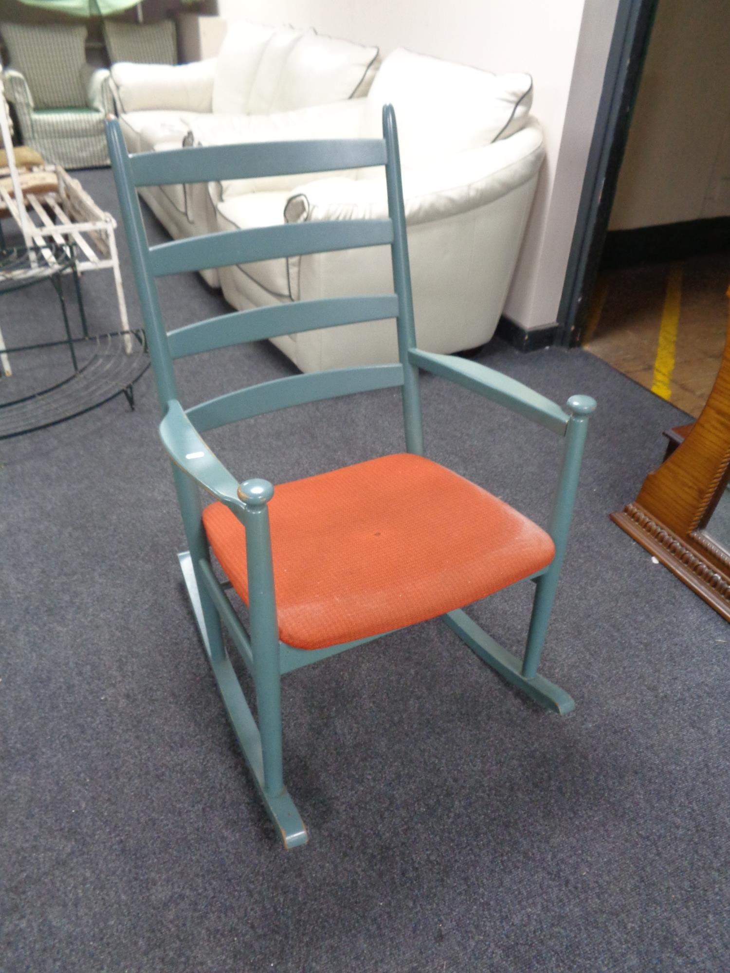 A mid century ladder backed rocking chair