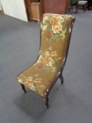 A Victorian nursing chair with mahogany frame