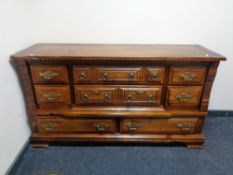 A rustic pine eight drawer chest with brass drop handles