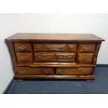 A rustic pine eight drawer chest with brass drop handles