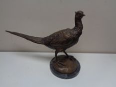 A bronzed metal figureof a pheasant, on marble base.