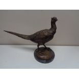 A bronzed metal figureof a pheasant, on marble base.