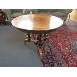 A continental mahogany and ebonised circular dining table