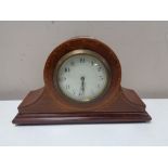 An antique French inlaid mahogany mantel clock on raised brass feet, with key.
