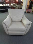 A cream leather swivel reclining armchair