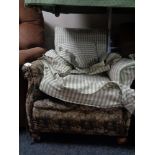 A Victorian horse hair filled armchair in a floral fabric with green check loose cover
