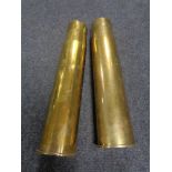 A pair of large brass ammunition shells