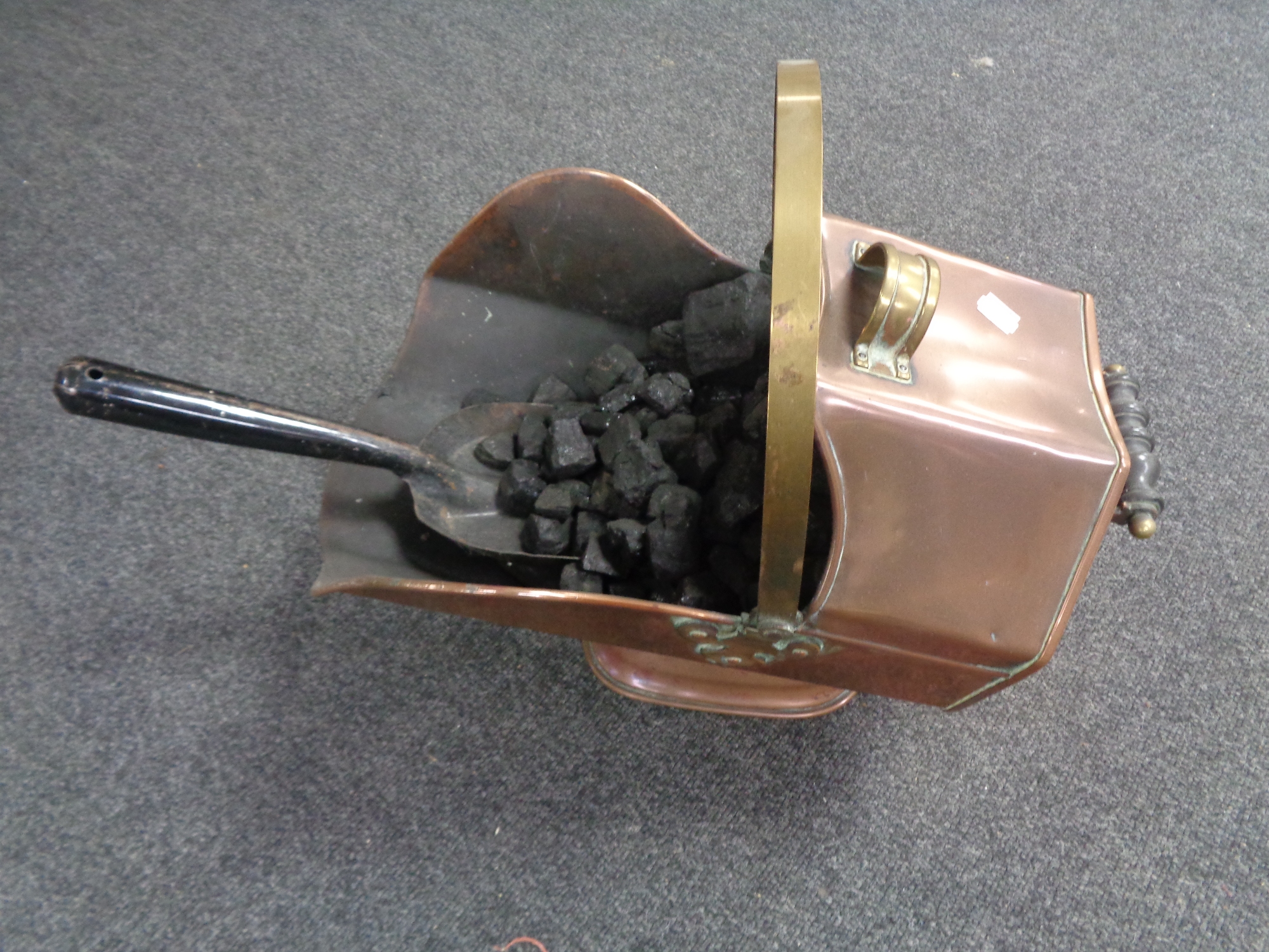 A Victorian copper and brass coal receiver with shovel.