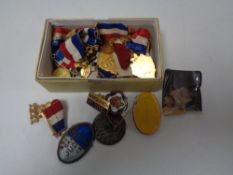 A box of British Empire Games medals, cross country medals, enamelled badges,