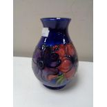 A Moorcroft vase, anemone flowers on dark blue ground, height 13.5 cm.