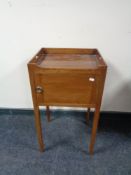 A late Victorian bedside cabinet on raised legs