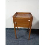 A late Victorian bedside cabinet on raised legs