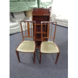 A pair of inlaid mahogany occasional chairs and open bookcase