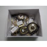 A box of horse brasses some on leather straps