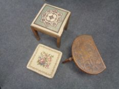 A carved milking stool (leg needing attention) and two other stools