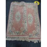 Two fringed Chinese rugs on blue ground