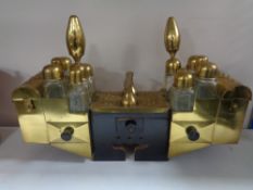 A Middle Eastern brass chest with glass bottles