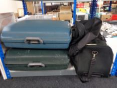 Two hardshell luggage cases together with a bag of various holdalls