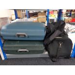 Two hardshell luggage cases together with a bag of various holdalls