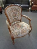 A continental beech framed armchair in tapestry fabric