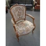 A continental beech framed armchair in tapestry fabric