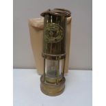 A brass E. Thomas & Williams miner's lamp.