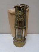 A brass E. Thomas & Williams miner's lamp.