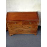 A late 19th century mahogany bureau on bracket feet