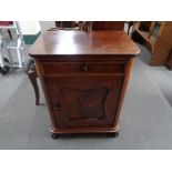 An antique mahogany and pine single door cupboard