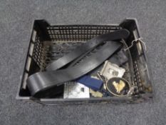 A box of two leather belts and four ornate belt buckles.