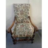 A 20th century carved oak scroll arm armchair