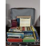 A vintage case containing hardbacked books,
