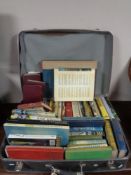 A vintage case containing hardbacked books,