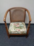 An early twentieth century bergere backed armchair