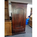 An antique pine single door wardrobe