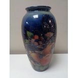 A Moorcroft vase of pomegranate and bird design, height 25 cm.
