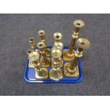 A tray of five pairs of brass candlesticks