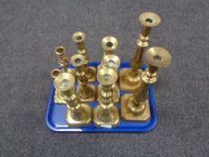 A tray of five pairs of brass candlesticks