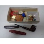 A box of pocket compasses, medals, enamelled badges, cuff links,