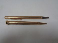 Two 9ct gold mechanical pencils.