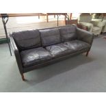 A mid 20th century Danish brown leather three seater settee