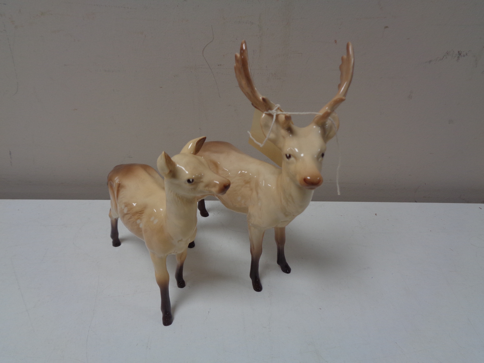 A pair of Beswick figures, stag with doe.