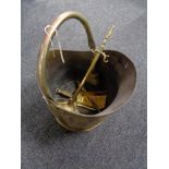 An antique brass coal bucket and companion set